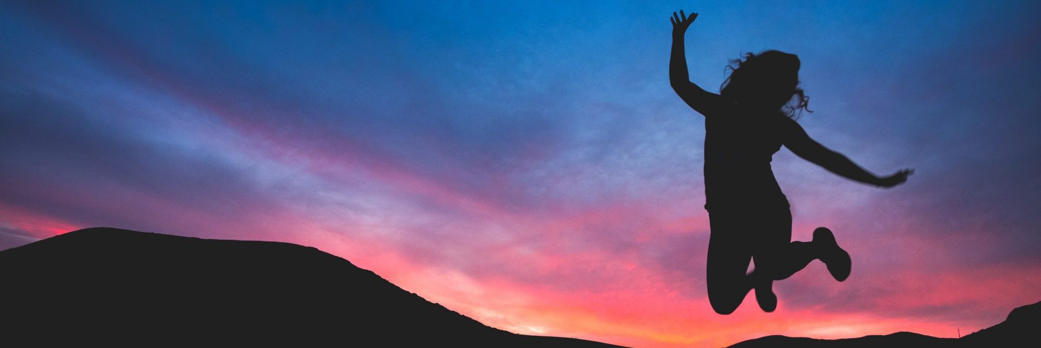 Stock photo silhouette of woman jumping in air